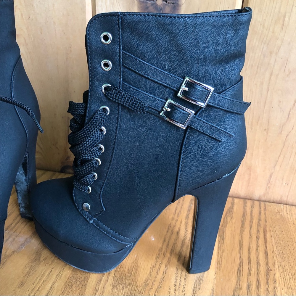 Black platform calf length boots with ties and buckles